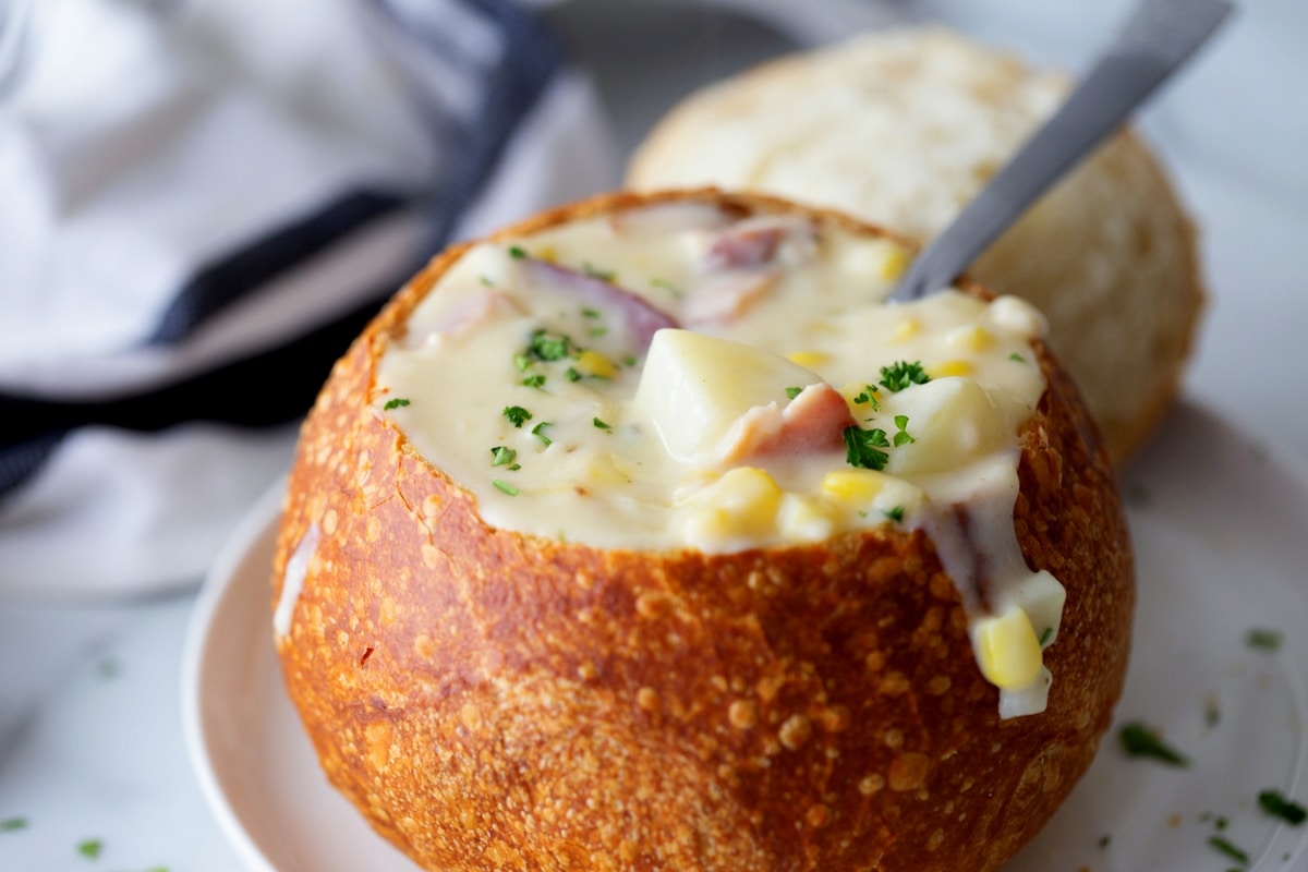 Creamy corn chowder in a sourdough bread bowl Corn chowder in a sourdough bowl with creamy texture