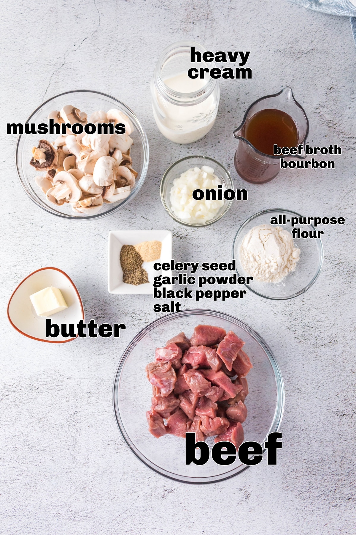 Ingredients for beef stroganoff with heavy cream, bourbon, mushrooms, onions, and sliced beef