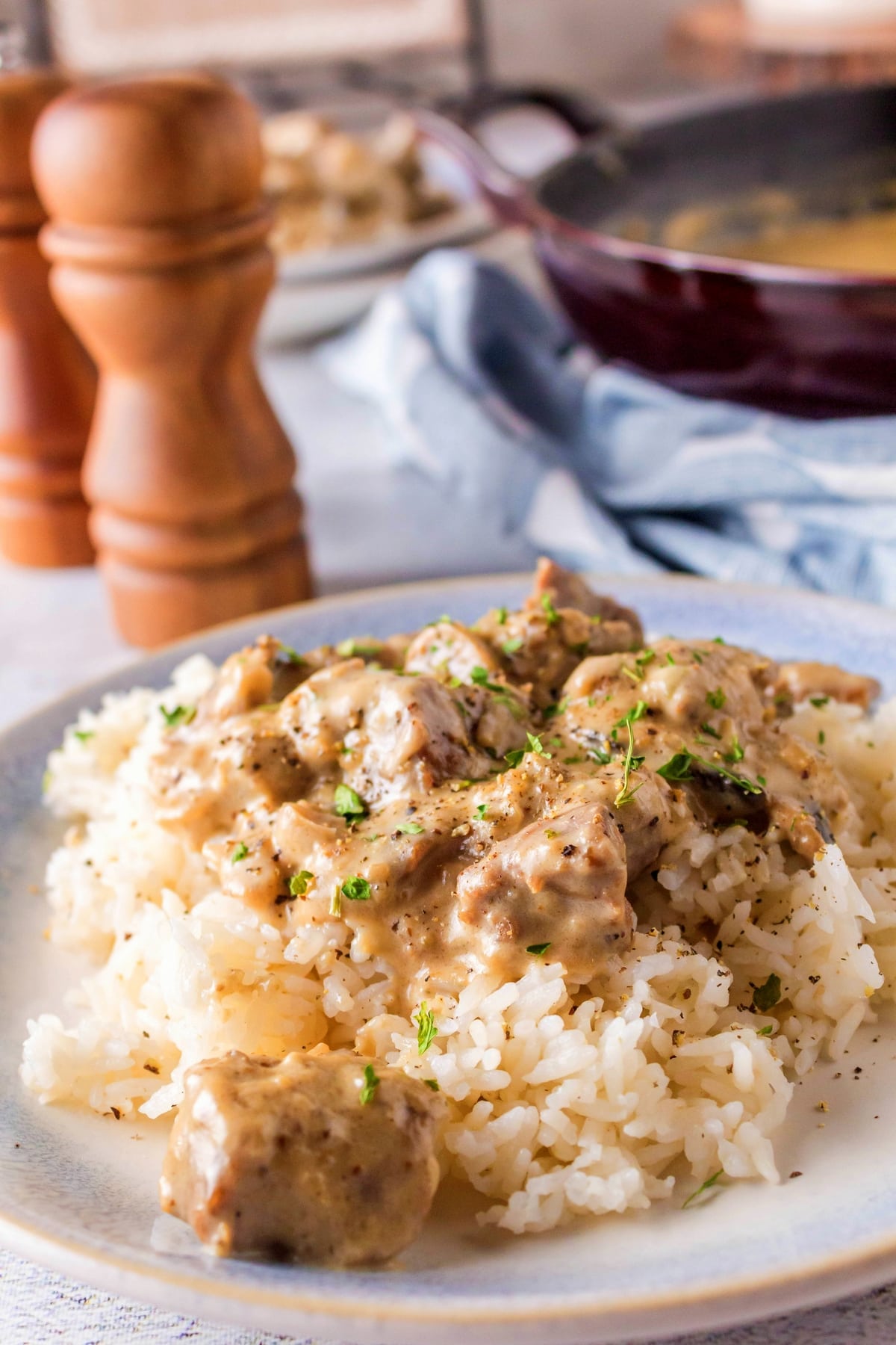 Close-up of beef stroganoff in creamy sauce served over rice