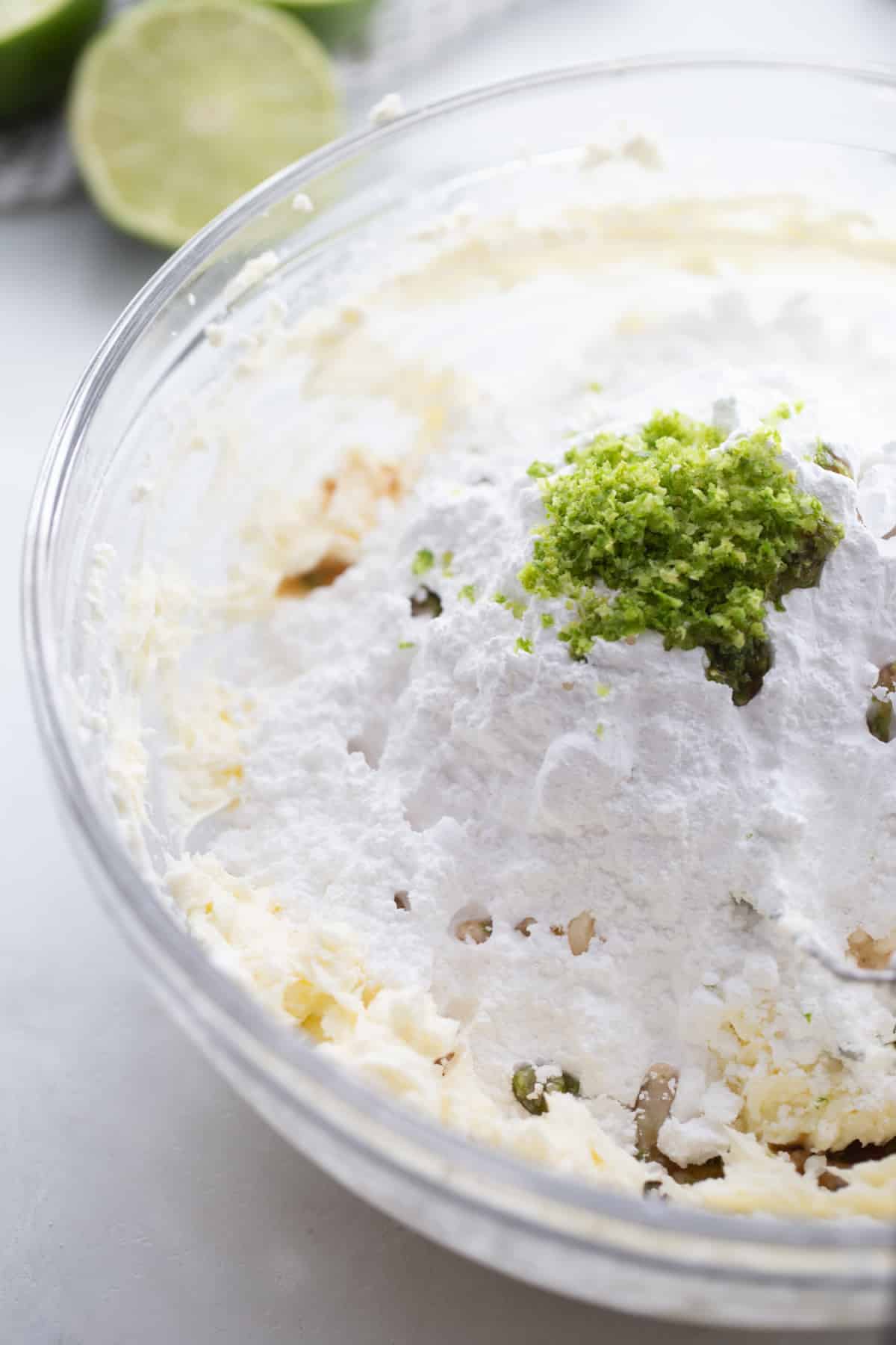 Cupcake batter with zest and juice visible, not yet mixed