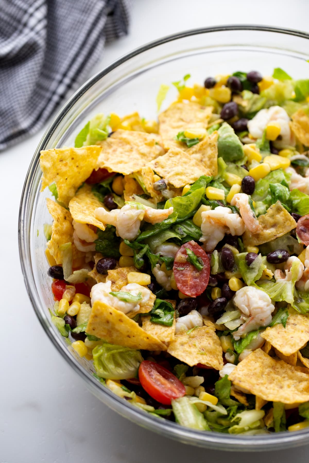 Shrimp and Avocado Taco Salad in a bowl This shrimp and avocado taco salad is a fresh, zesty Tex-Mex dish loaded with shrimp, corn, and a simple homemade dressing. Perfect for weeknight meals!