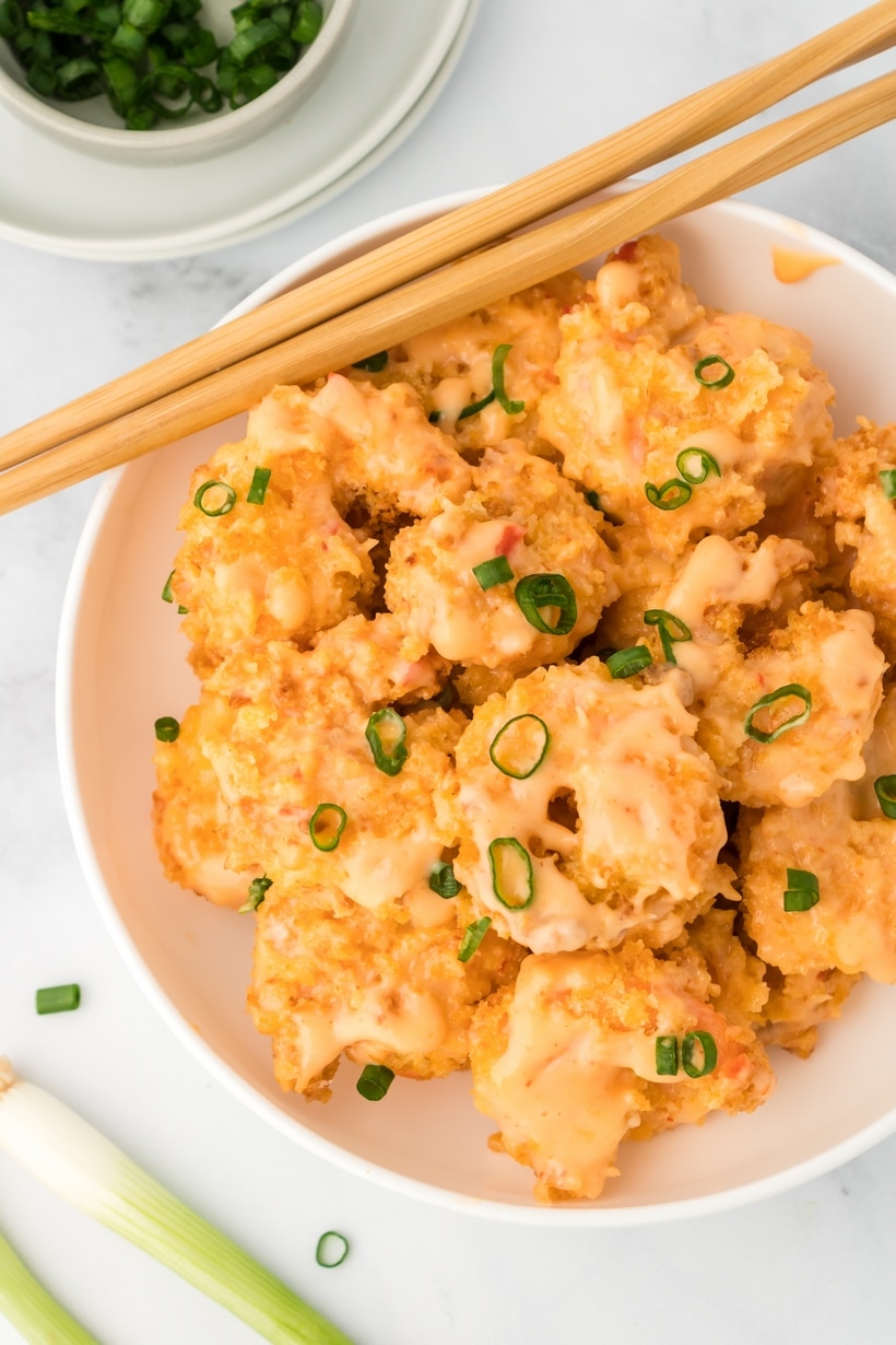 crispy bang bang shrimp in air fryer with sweet chili sauce Air fryer bang bang shrimp served in a white bowl with spicy chili mayo