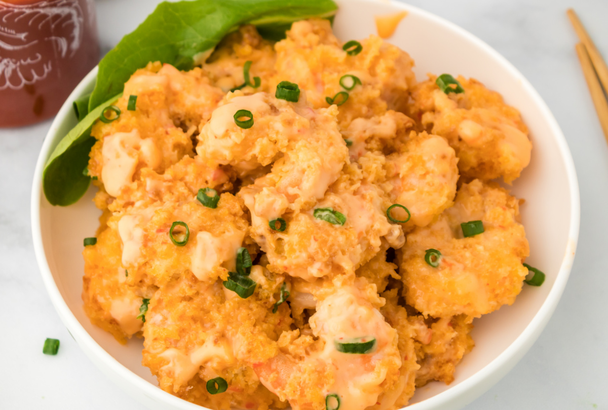 air fryer shrimp with creamy sweet chili Sriracha sauce Overhead shot of golden panko-crusted shrimp tossed in bang bang sauce