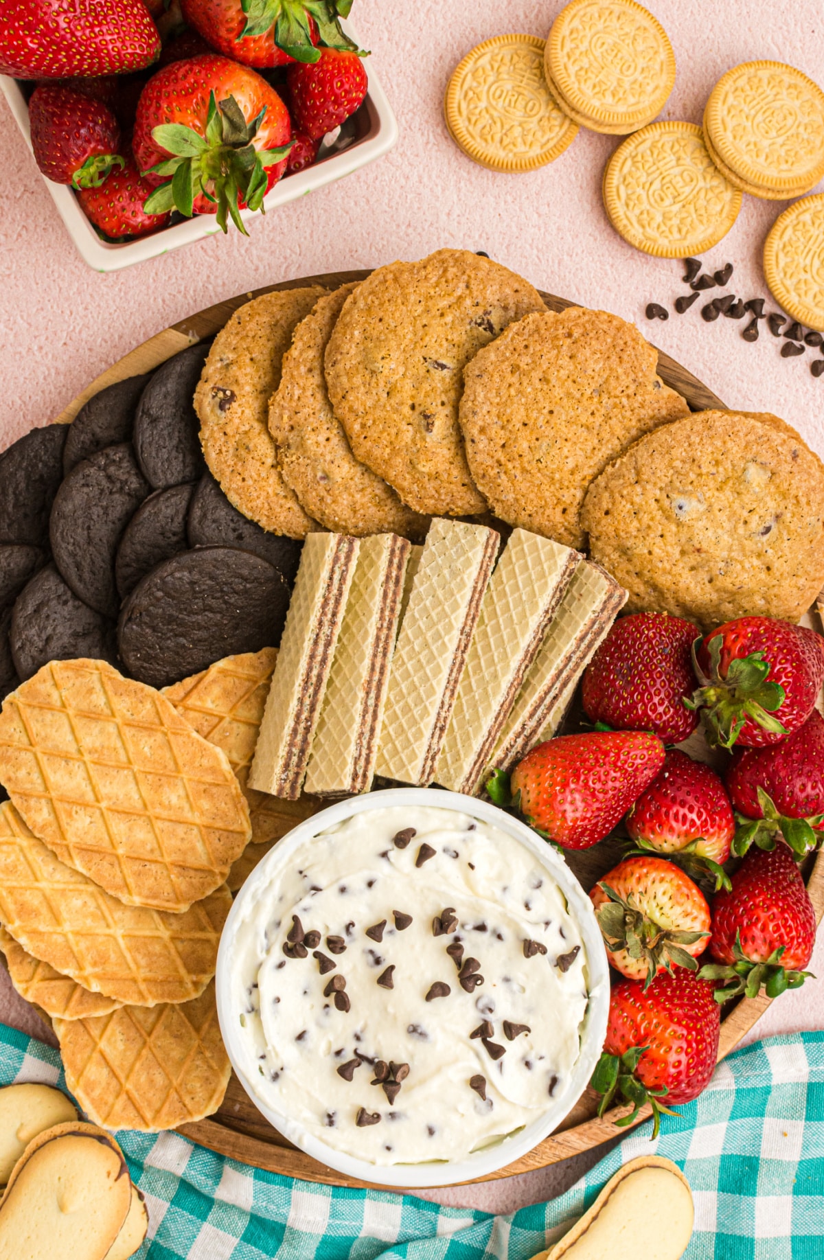 Cannoli dip with assorted dippers Overhead view of cannoli dip on a tray surrounded by cookies, waffle cones, and other dippers