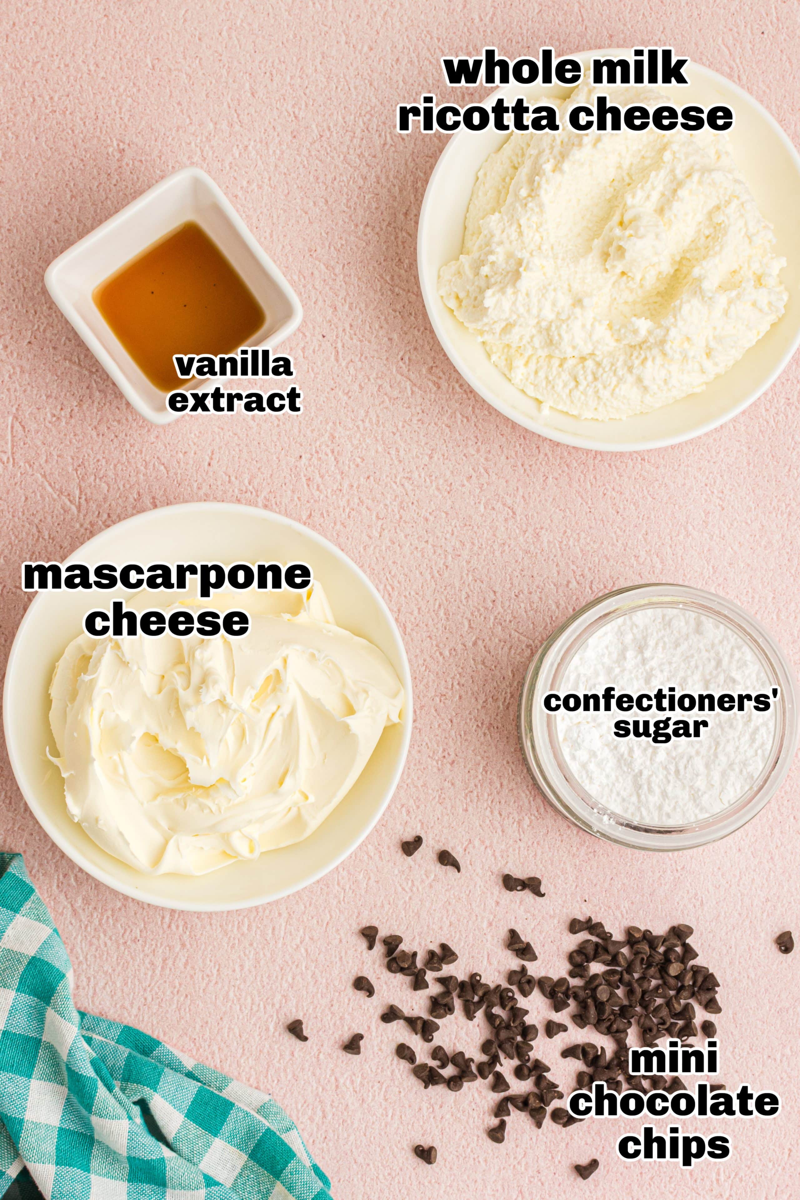 Cannoli dip ingredients Ingredients for cannoli dip laid out, including ricotta, mascarpone, confectioners’ sugar, chocolate chips, and vanilla