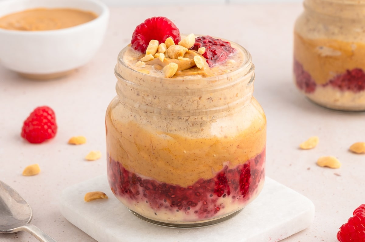 Finished Peanut Butter and Jelly Overnight Oats in a bowl with a layer of peanut butter and jelly on top.