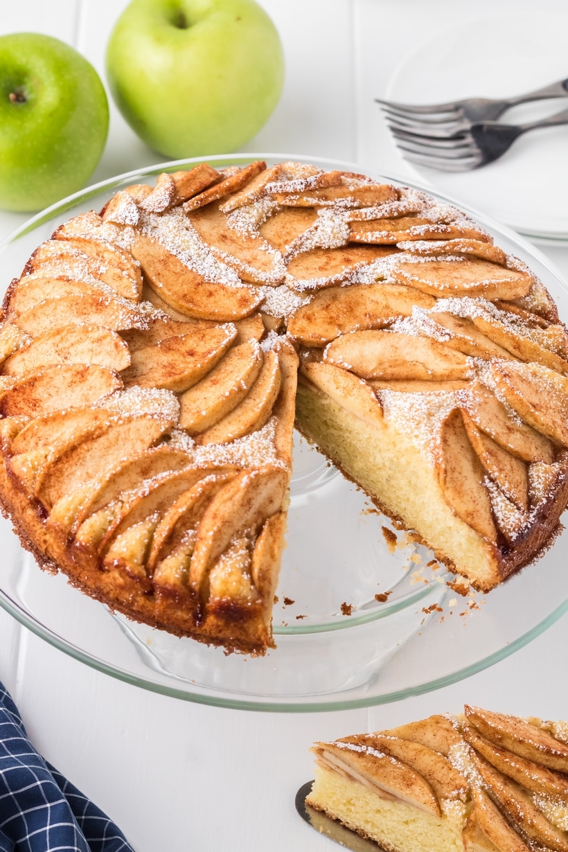 German Apple Cake is a favorite, single-layered dessert. The simple, vanilla-flavored batter rises perfectly around thinly sliced, fanned apples and finished with a generous dusting of confectioners' sugar. apple cake german