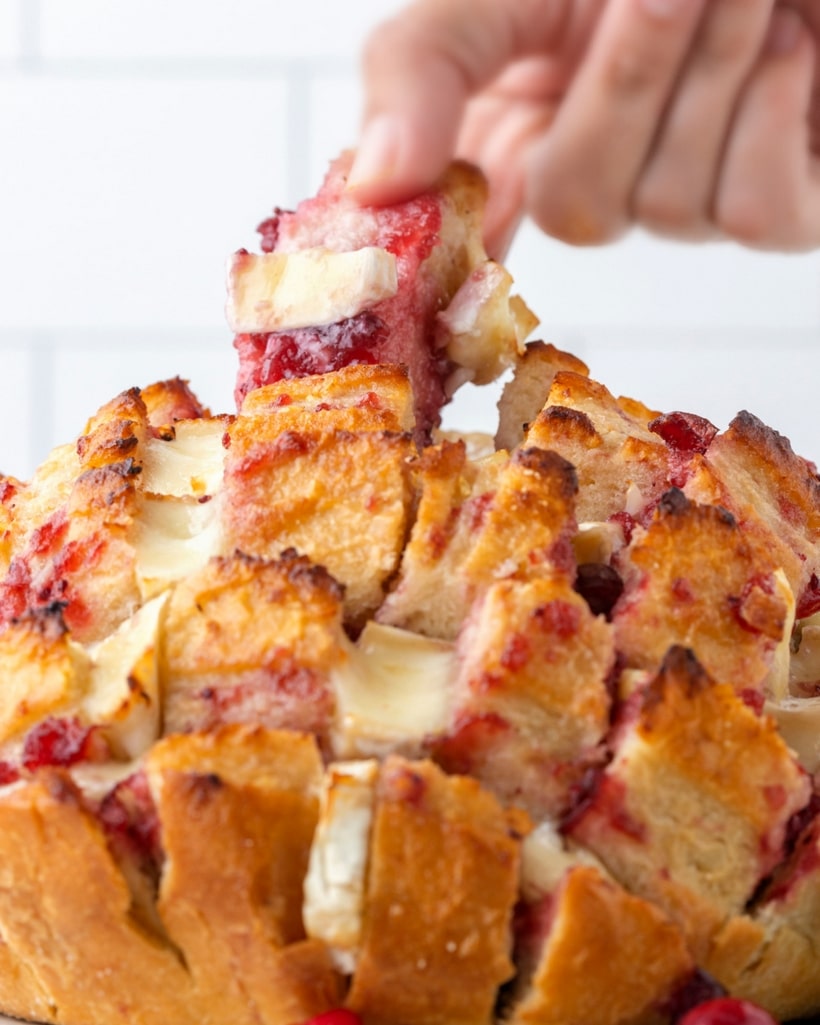 Gooey cheese and bread are always a good idea, but spoon in cranberry sauce and you instantly have a festive, fall appetizer on your hands. This Cranberry Pull-Apart Bread is guaranteed to be the hit of the party. Cranberry brie Pull-Apart Bread
