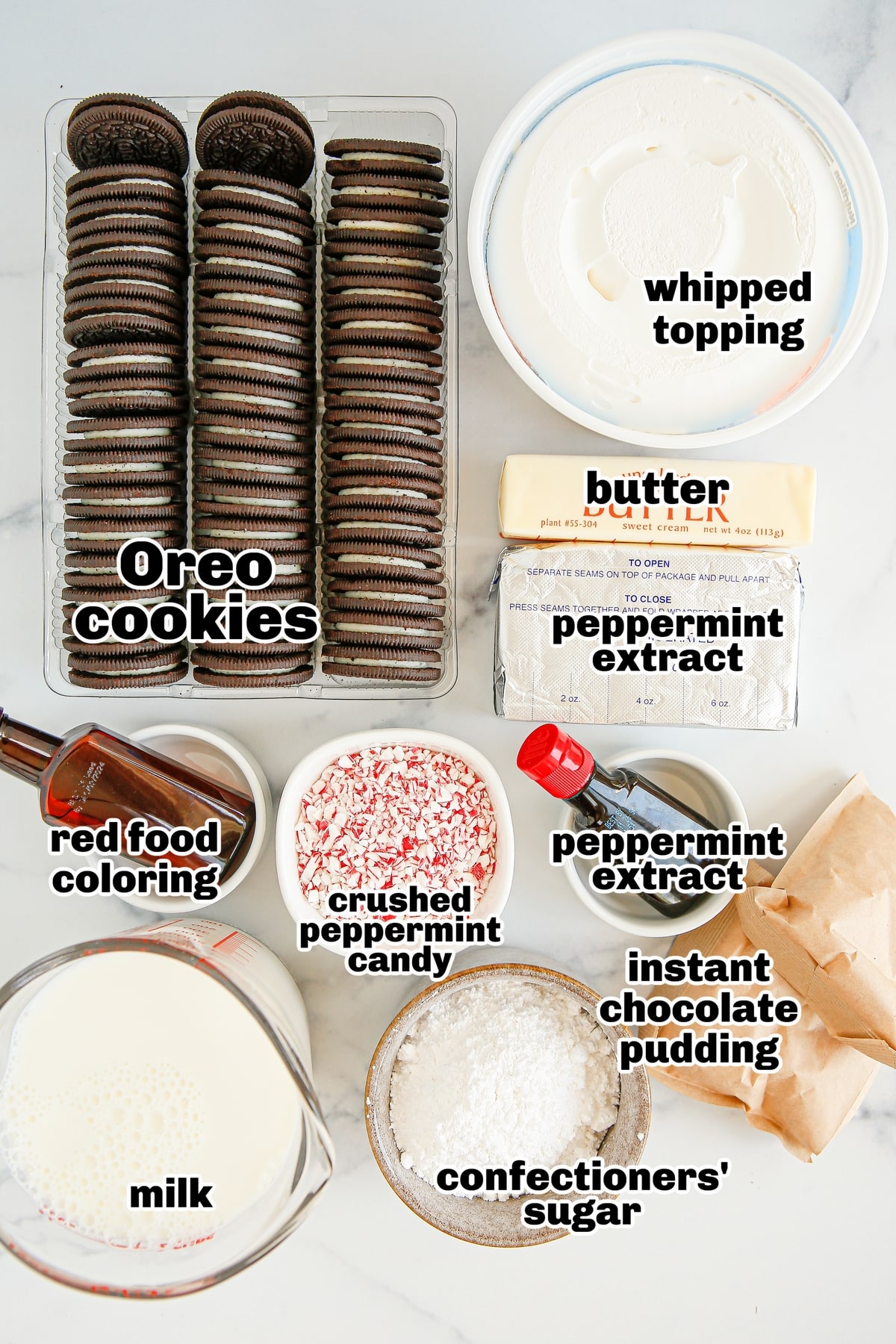 Ingredients for Chocolate Peppermint Lush Recipe Ingredients laid out, including Oreos, cream cheese, powdered sugar, whipped topping, candy canes, and chocolate pudding mix.