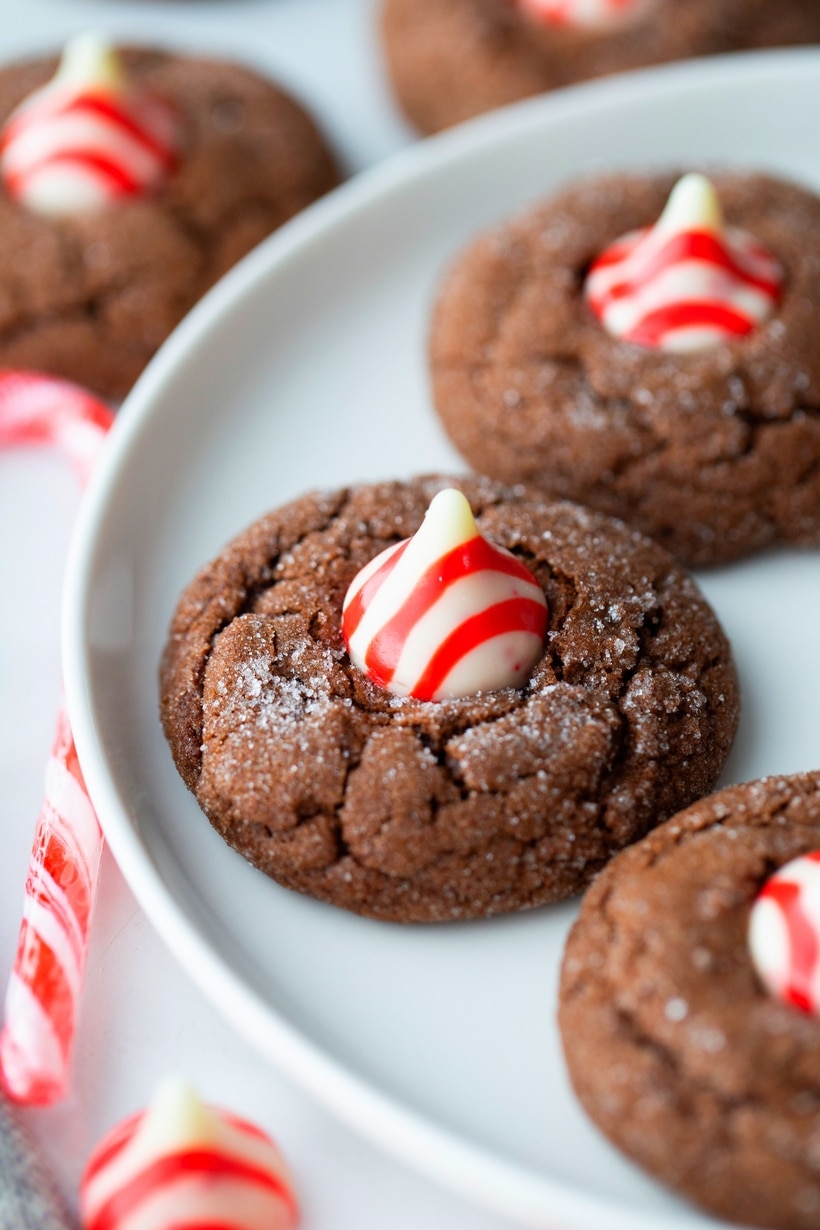 close-up of a dark chocolate peppermint crackle cookie Dark Chocolate Peppermint Crackle Cookie highlighting the crackle and Hershey's Kiss.