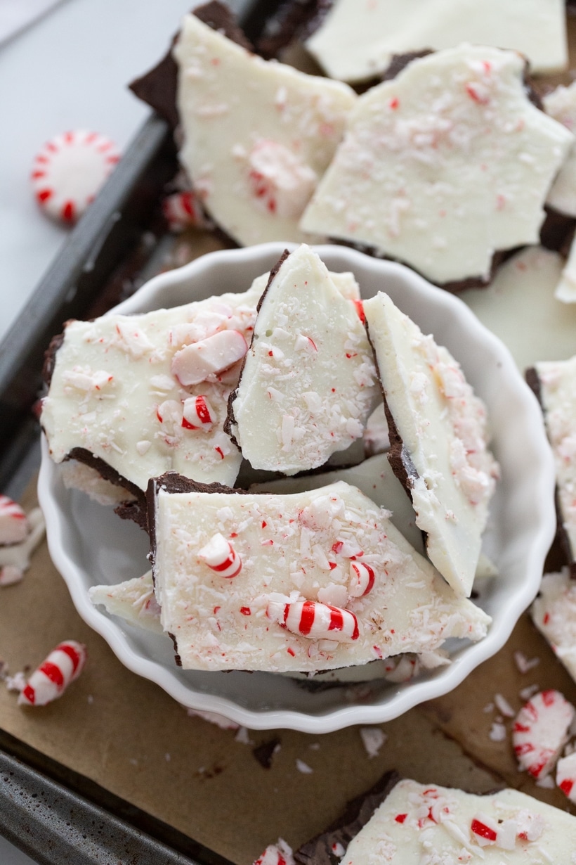 Overhead shot of broken pieces of double chocolate peppermint bark in a ramekin.