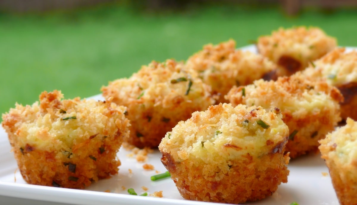 Mini crab cakes arranged on a white platter.