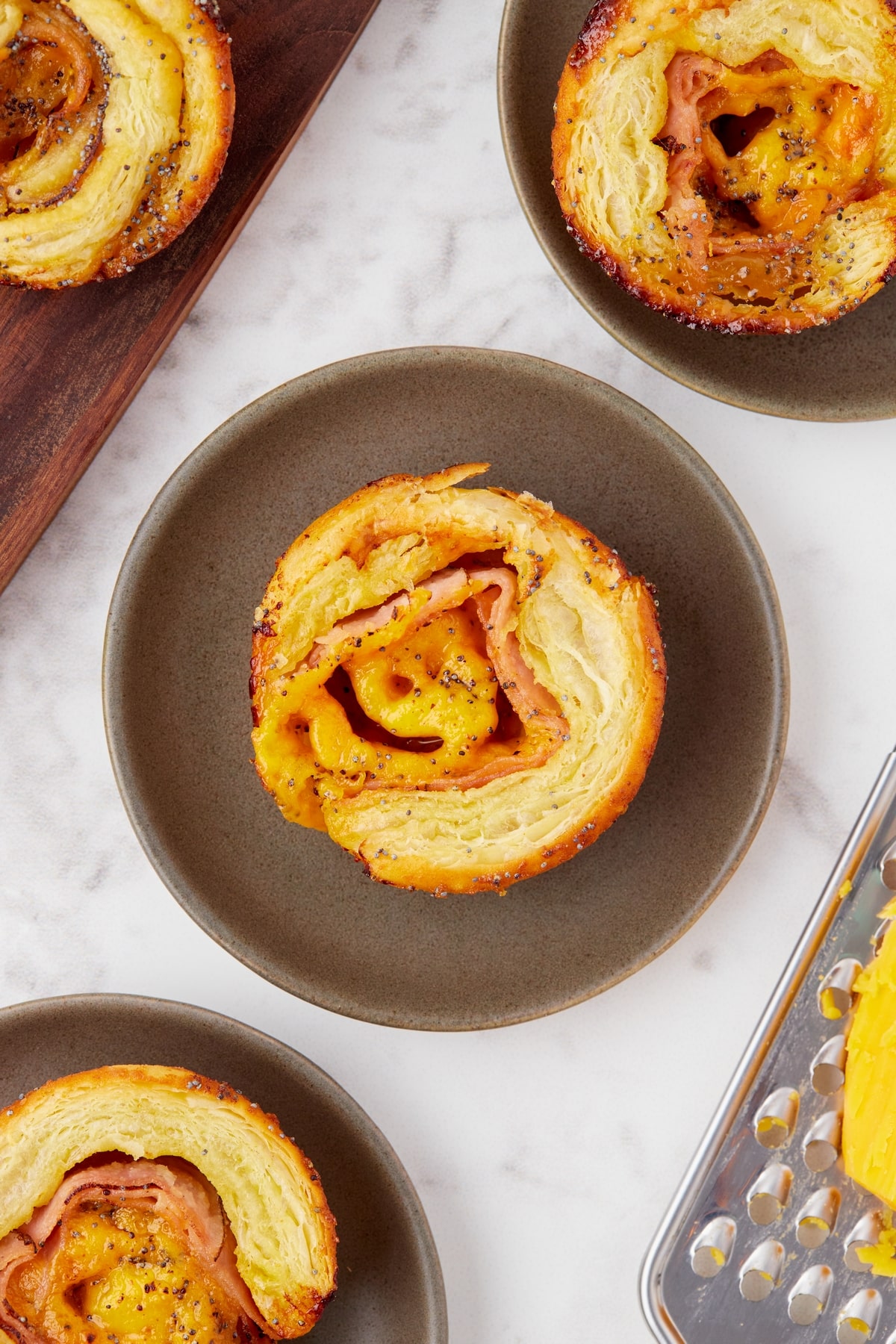 Bite-sized ham and cheese pinwheels served on a platter, perfect for snacking.
