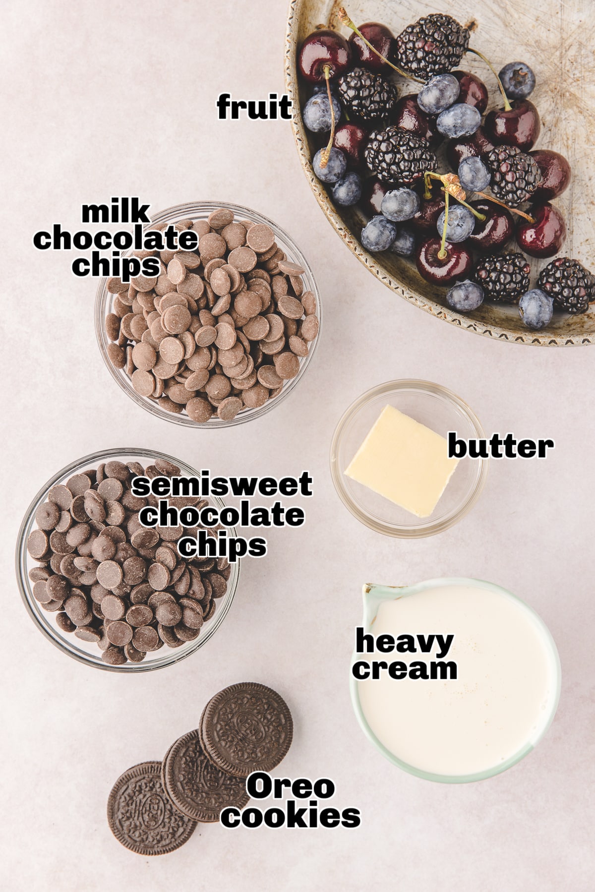 Mini Chocolate Ganache Tarts ingredients All five ingredients for the mini chocolate ganache tarts laid out on a countertop, including Oreos, butter, chocolate chips, and cream.