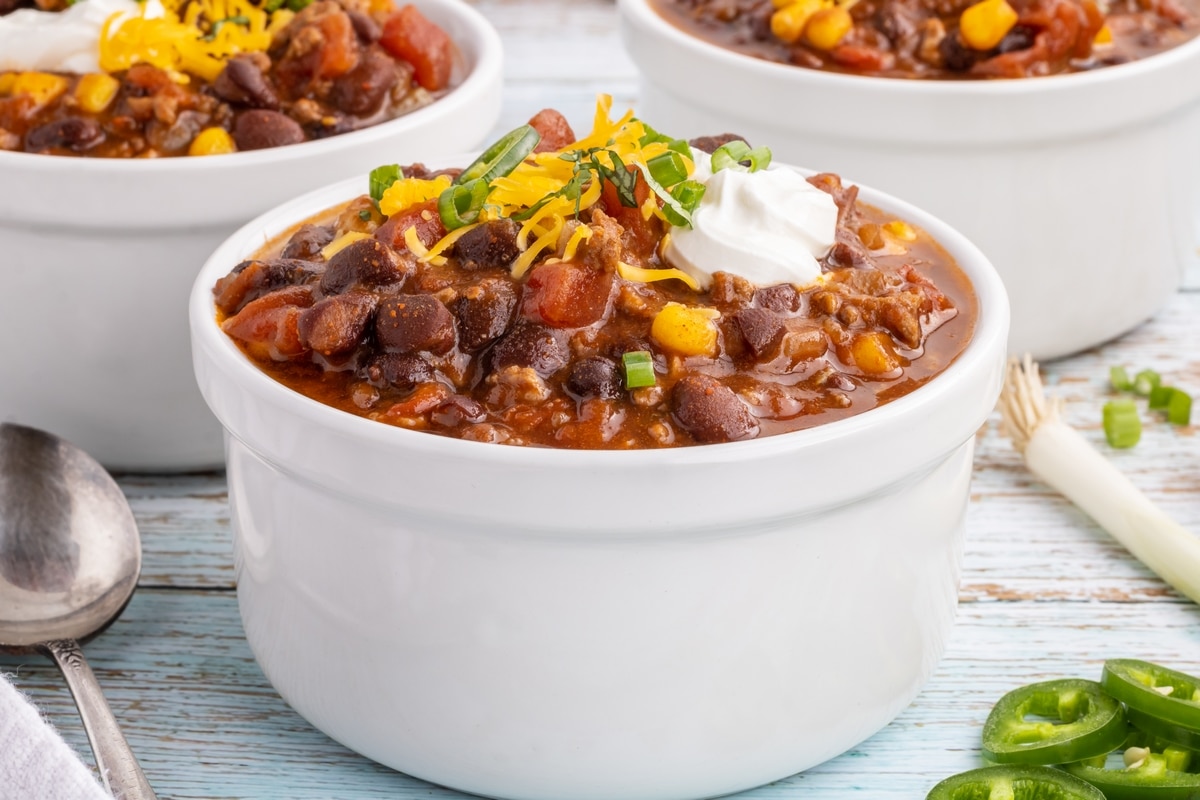 Taco soup, three bowls with toppings.