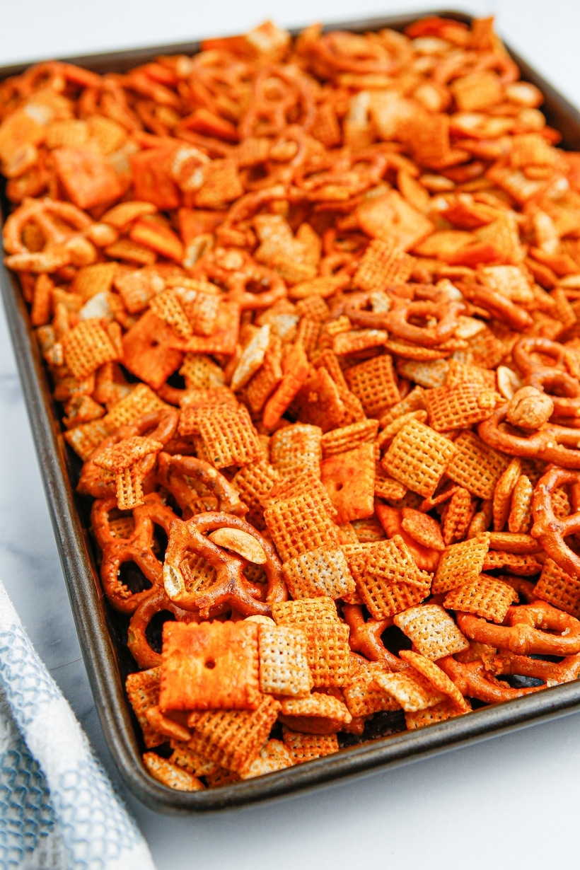 BBQ Chex mix spread on a baking tray BBQ Chex mix spread on a baking tray