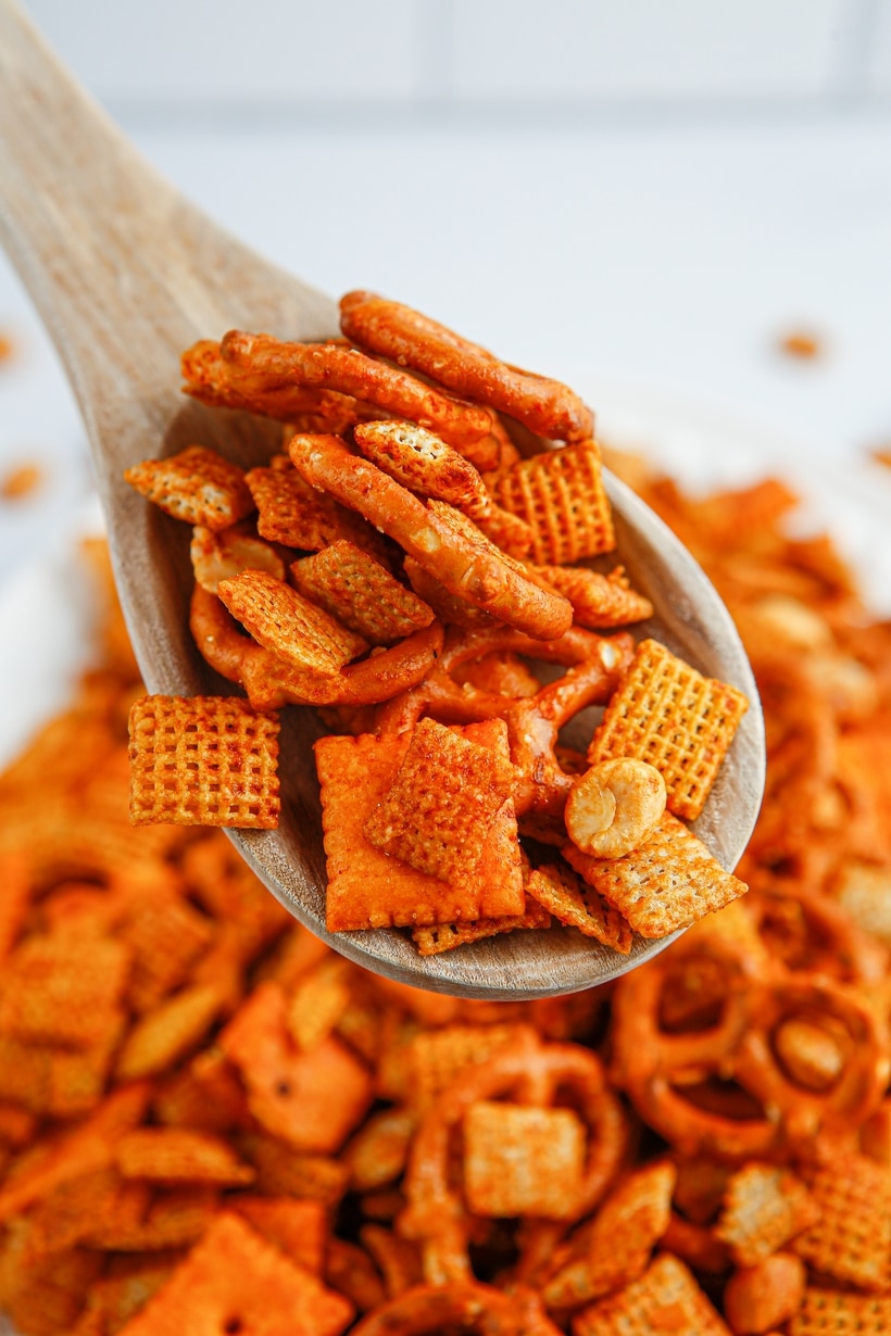 Scooping Chex mix with spoon Wooden spoon scooping up some BBQ Chex snack mix.