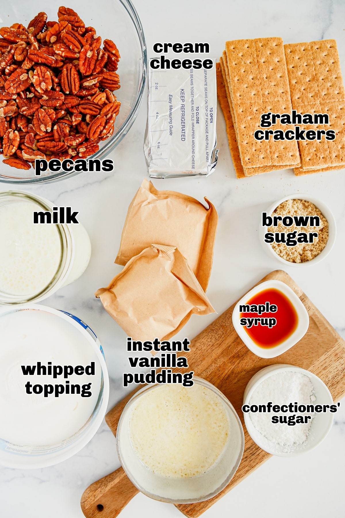 Ingredients for Pecan Cream Pie Lush Overhead view of ingredients for Pecan Cream Pie Lush, including graham crackers, pecans, cream cheese, and whipped topping.