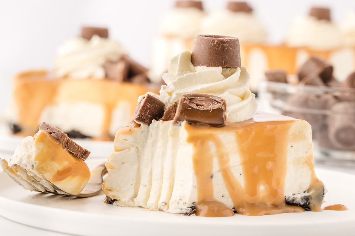 Bite of Rolo No-Bake Cheesecake on fork A bite of Rolo No-Bake Cheesecake on a fork, ready to be enjoyed.