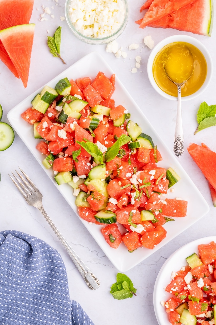 Cold watermelon feta mint salad tossed with honey-lime dressing Overhead shot of watermelon salad with focus on texture and dressing shine