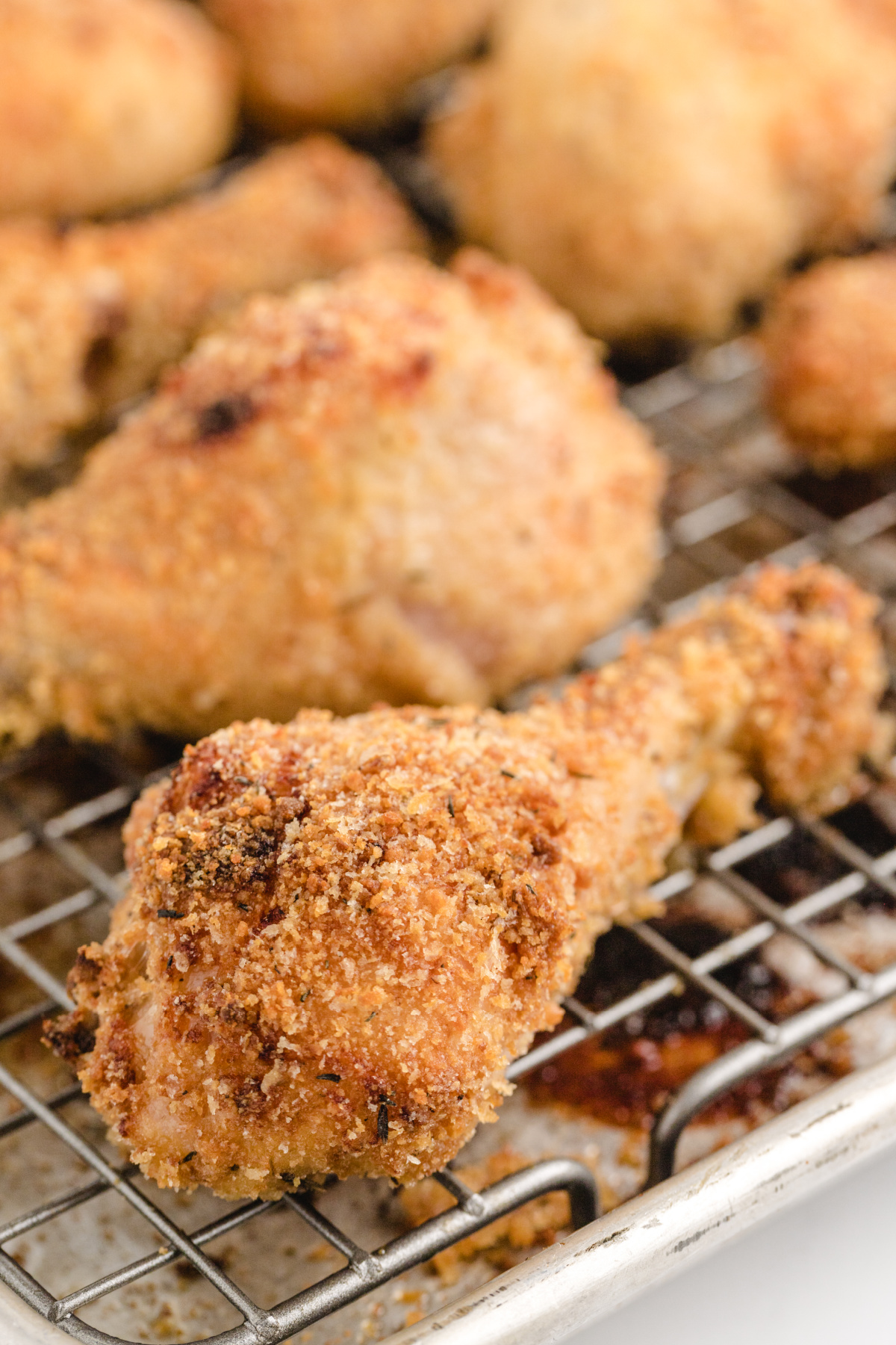 Crispy Panko Chicken Drumsticks close up of crispy panko coated chicken drumsticks cooling on a wire rack
