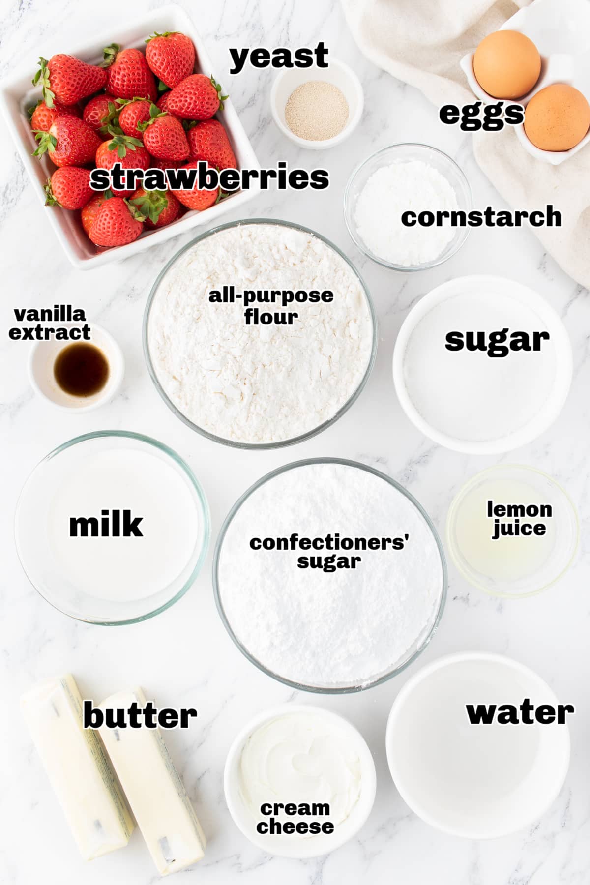 Strawberry Sweet Rolls ingredients Overhead view of all the ingredients laid out for making strawberry sweet rolls, including strawberries, flour, butter, and cream cheese.