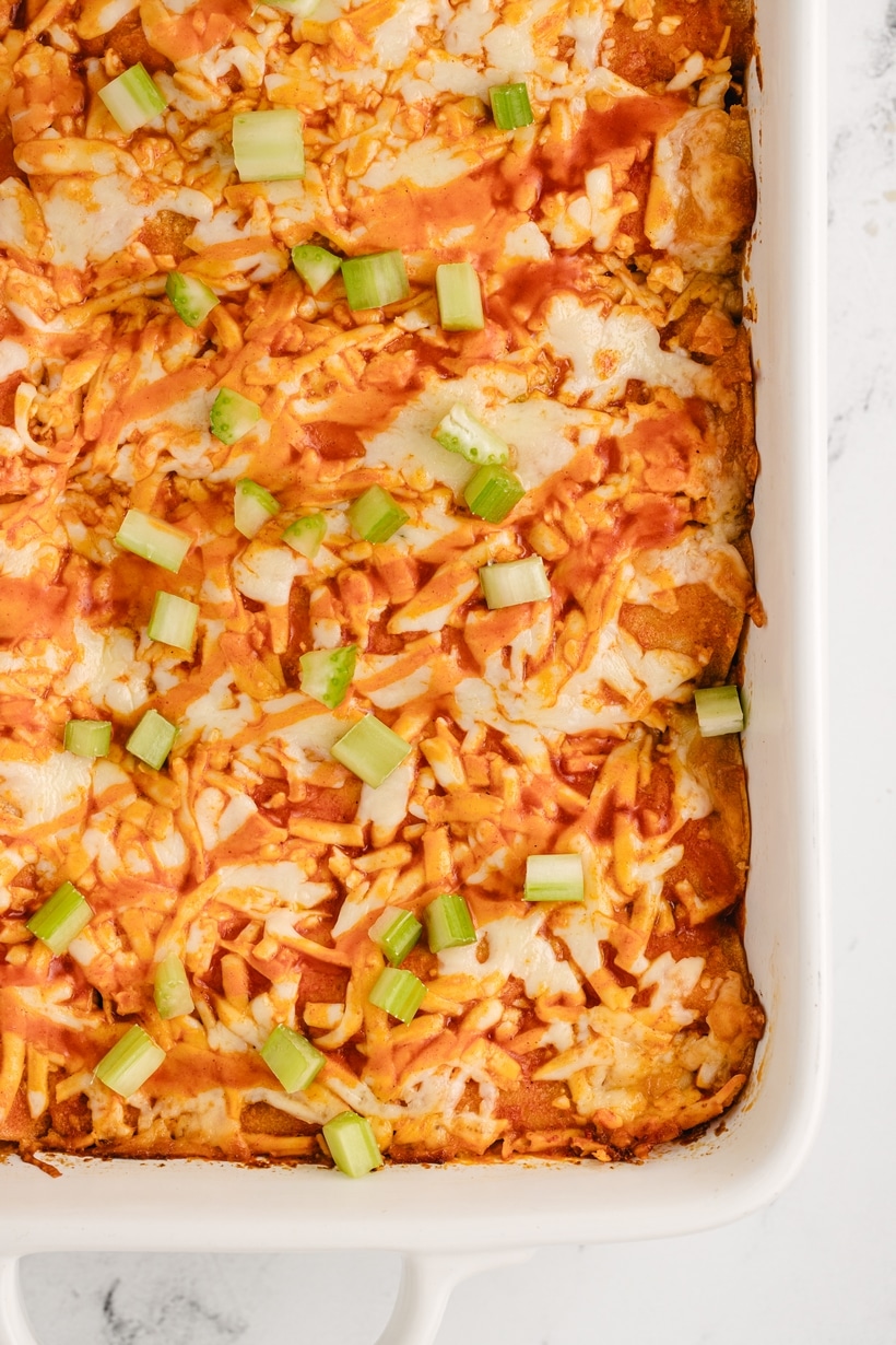 These buffalo chicken enchiladas are the creamiest, triple cheesy blend of fiery flavors, packed with shredded chicken, a zesty buffalo sauce, and lots of tortillas, all baked to perfection. Each bite delivers a punch of flavor that's downright addictive. This enchilada dinner is perfect for game day at home or for tailgating. They also make a great weeknight dinner. game day enchiladas