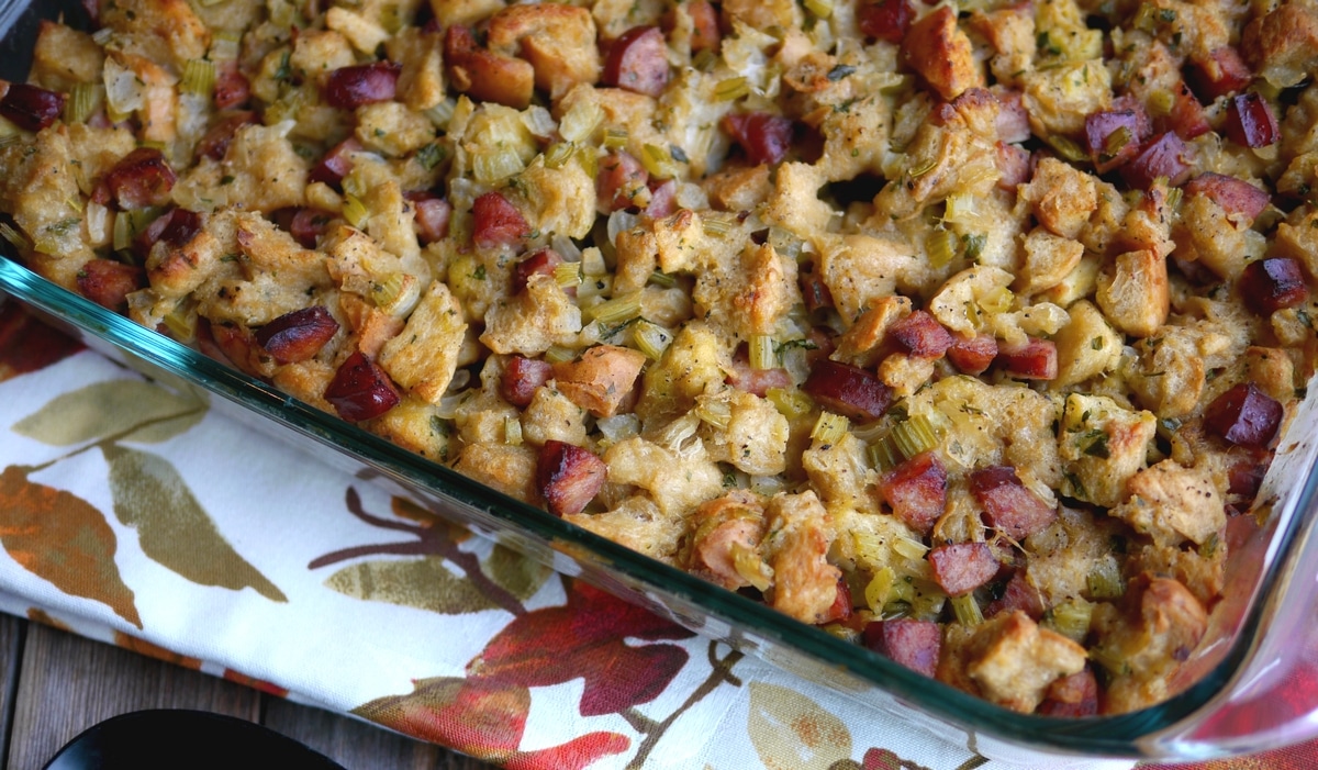 op view of baked challah bread and kielbasa stuffing in dish Overhead view of golden-brown challah bread and kielbasa stuffing in a baking dish.