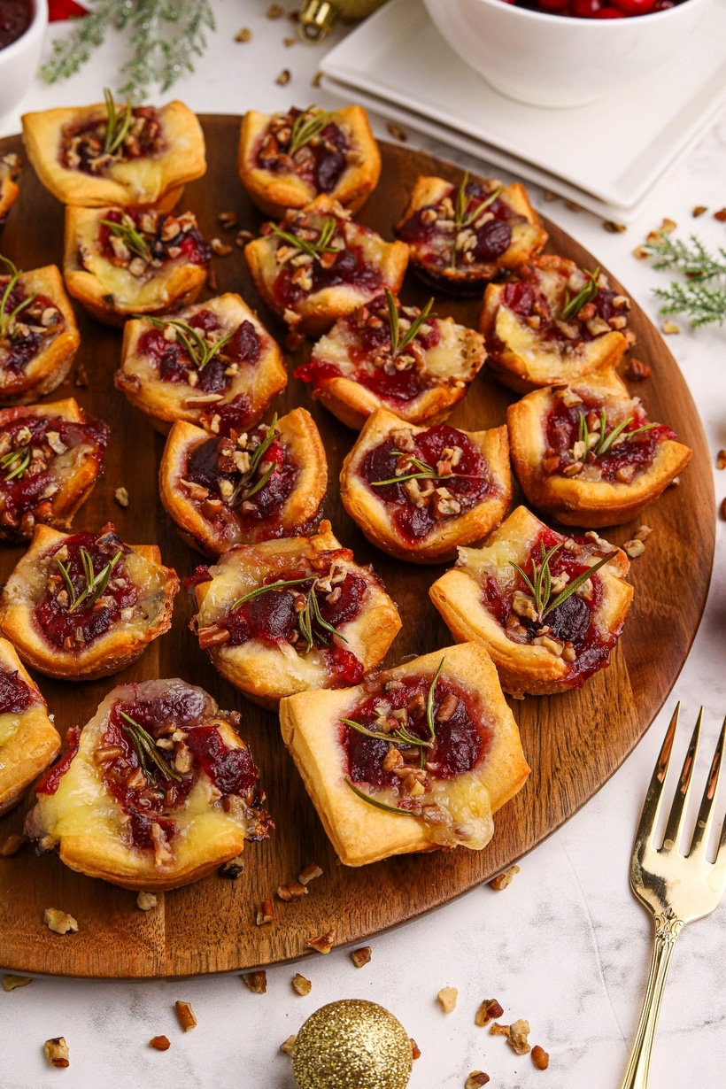 These cranberry Brie bites bring together gooey cheese, tart cranberry, and a hint of rosemary—all wrapped up in golden, buttery dough. Simple, festive, and always a hit. cranberry brie bites