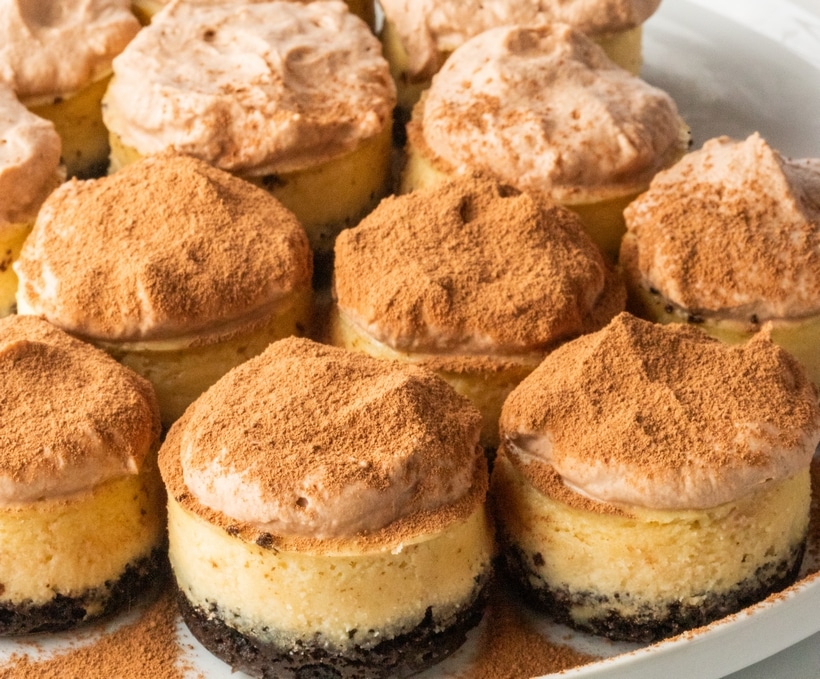 These irresistible mini-sized espresso cheesecakes are nestled on a Oreo cookie base and crowned with a luscious cloud of chocolate whipped topping that is generously dusted with cocoa powder. These mini cheesecakes are an indulgence fit for any occasion, with a special nod to the holiday season. cheesecake with coffee