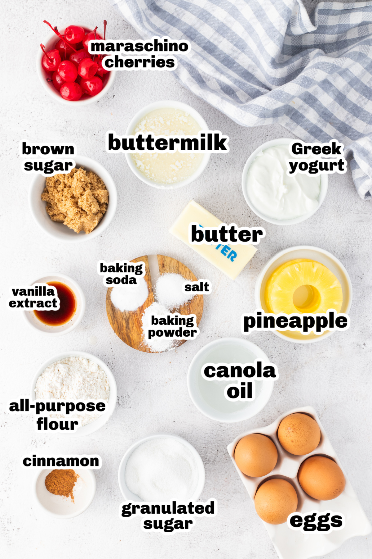 Labeled ingredients for pineapple upside down Bundt cake including pineapple rings, brown sugar, Greek yogurt, and eggs.