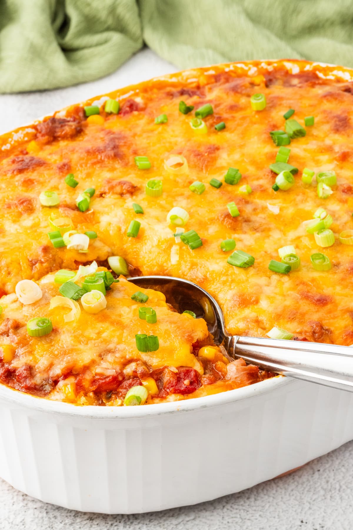 Cheesy ground beef pasta bake fresh from the oven Hot and bubbling ground beef pasta casserole with cheese and green onions