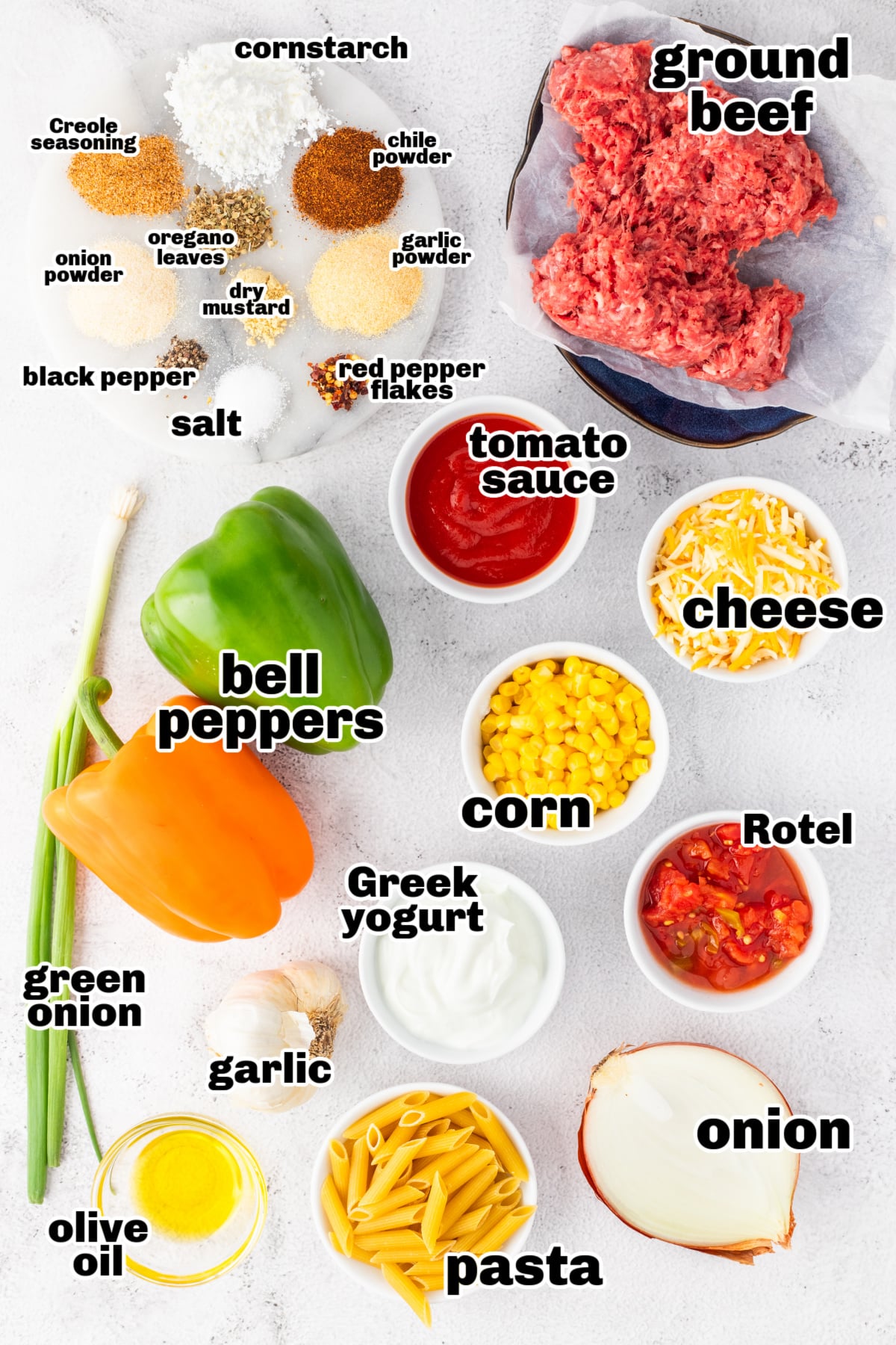 Ingredients laid out for easy ground beef casserole with peppers and pasta Ingredients for ground beef casserole with pasta, including peppers, beef, cheese, and seasonings