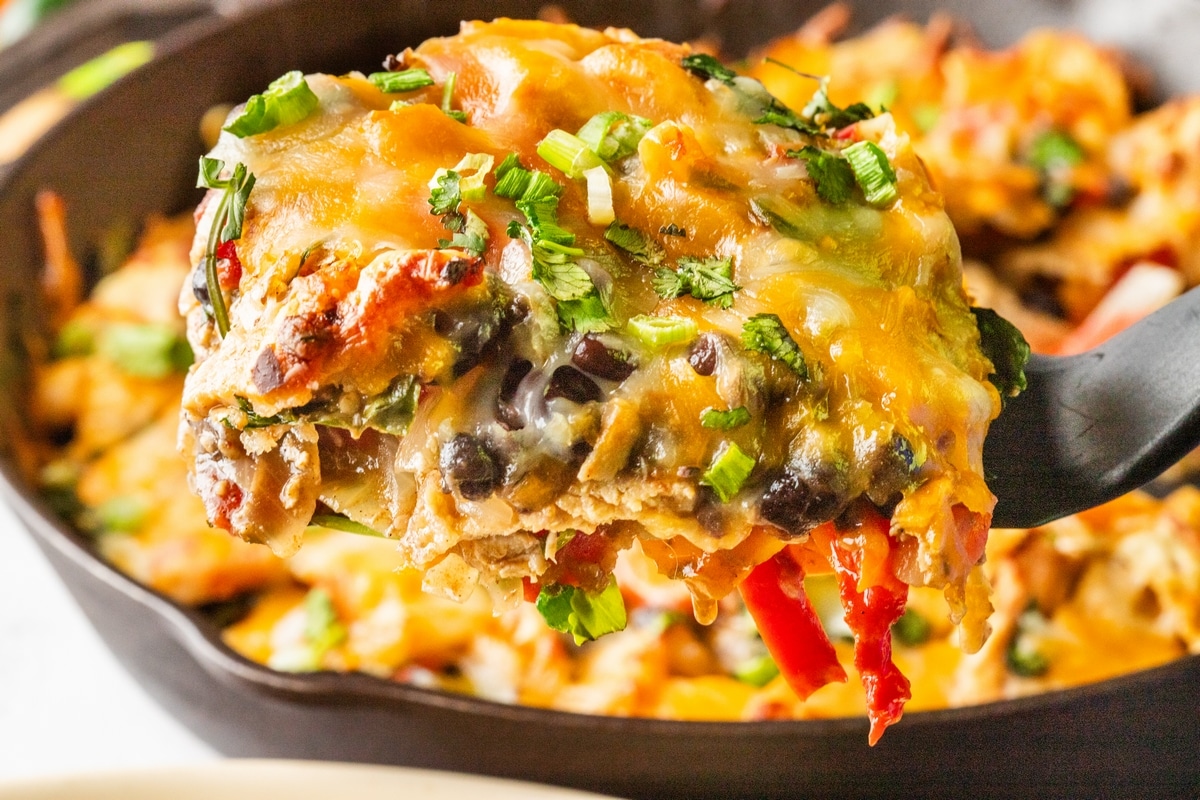 A portion of Chicken Fajita Casserole Chicken Fajita Casserole in a cast iron skillet