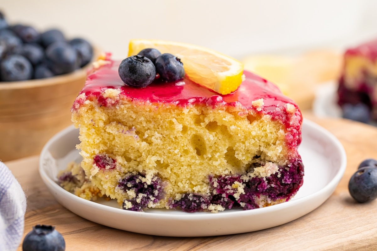 Treat yourself to a slice of heaven with my homemade blueberry lemon cake. It's the perfect balance of sweetness and citrus. a slice of lemon blueberry cake