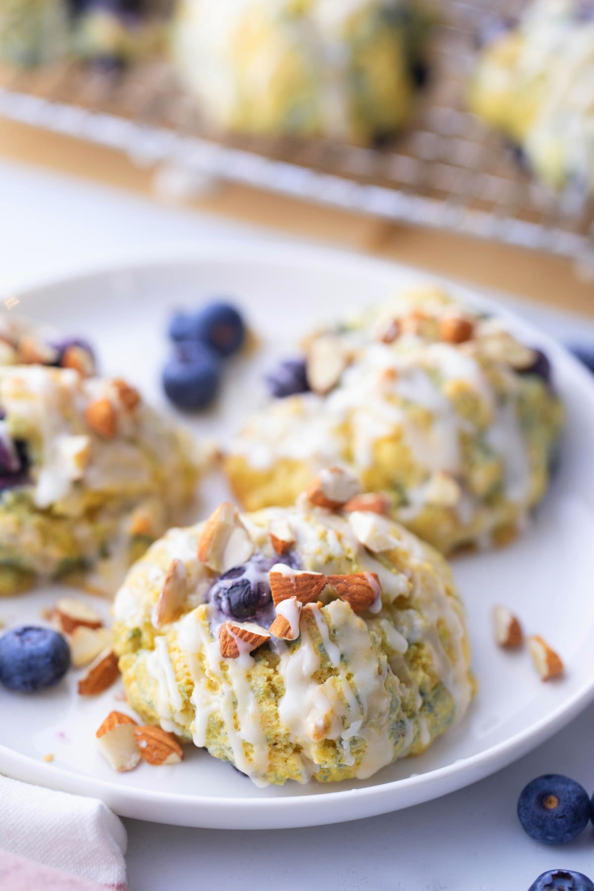 baked Cornmeal-Blueberry Drop Scones Overhead view of cornmeal-blueberry drop scones arranged on a plate, ready to serve.