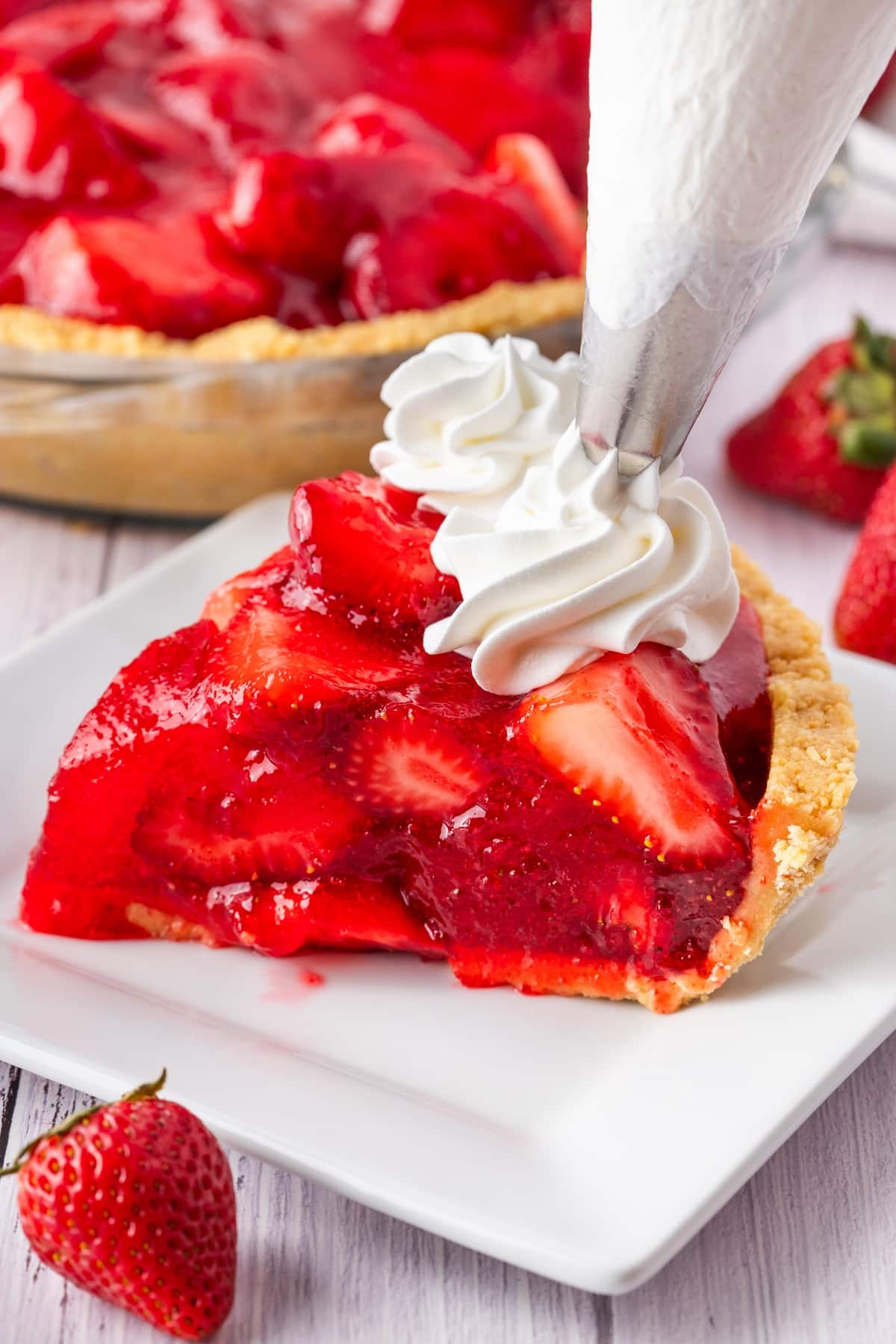 whipped cream on strawberry pie