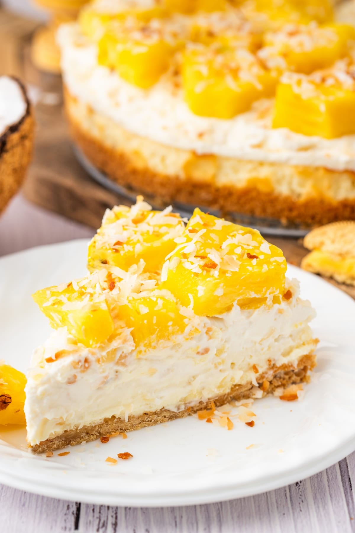 You'll love the tropical flavors of this pineapple delight cheesecake, featuring a golden Oreo crust, rich cream cheese layer, and fluffy pineapple mousse, topped with fresh pineapple and coconut. It's perfect for any gathering, from barbecues to potlucks. pineapple delight cheesecake