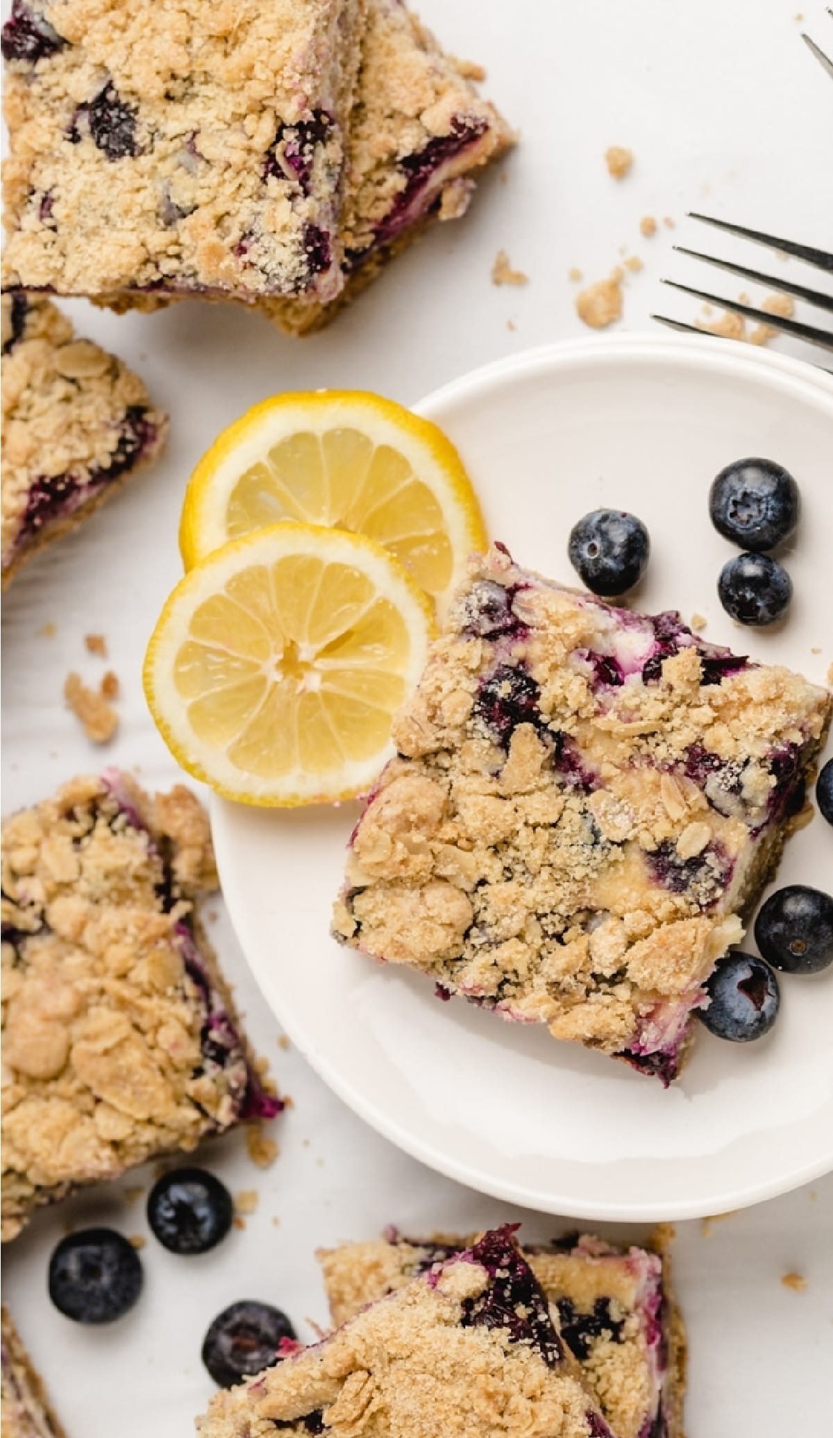 Crumb-topped lemon blueberry bars ready to serve Overhead shot of lemon blueberry bars arranged on a plate