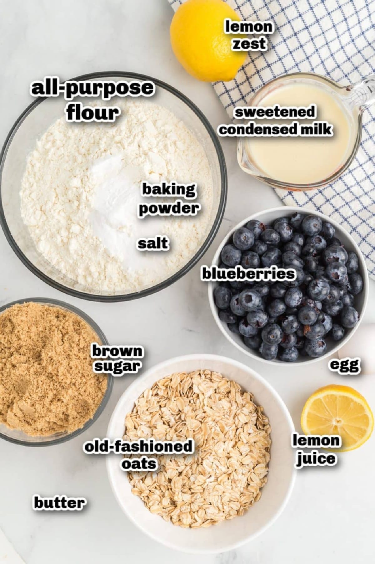 All ingredients needed to make lemon blueberry bars with oat streusel Measured ingredients for lemon blueberry crumble bars arranged on a counter