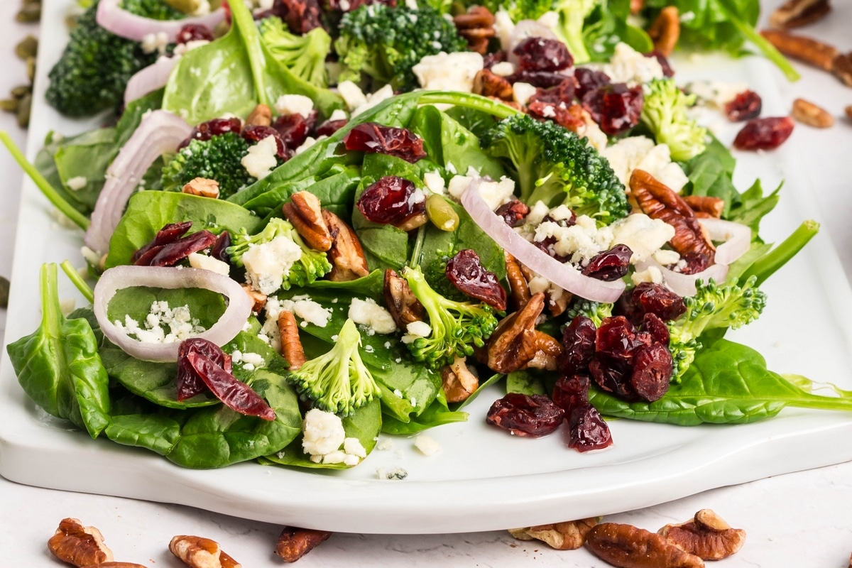 This spinach salad with Dijon vinaigrette comes together with crunchy pecans and sweet cranberries. It's simple, fresh, and has just the right balance of flavors. salad baby spinach