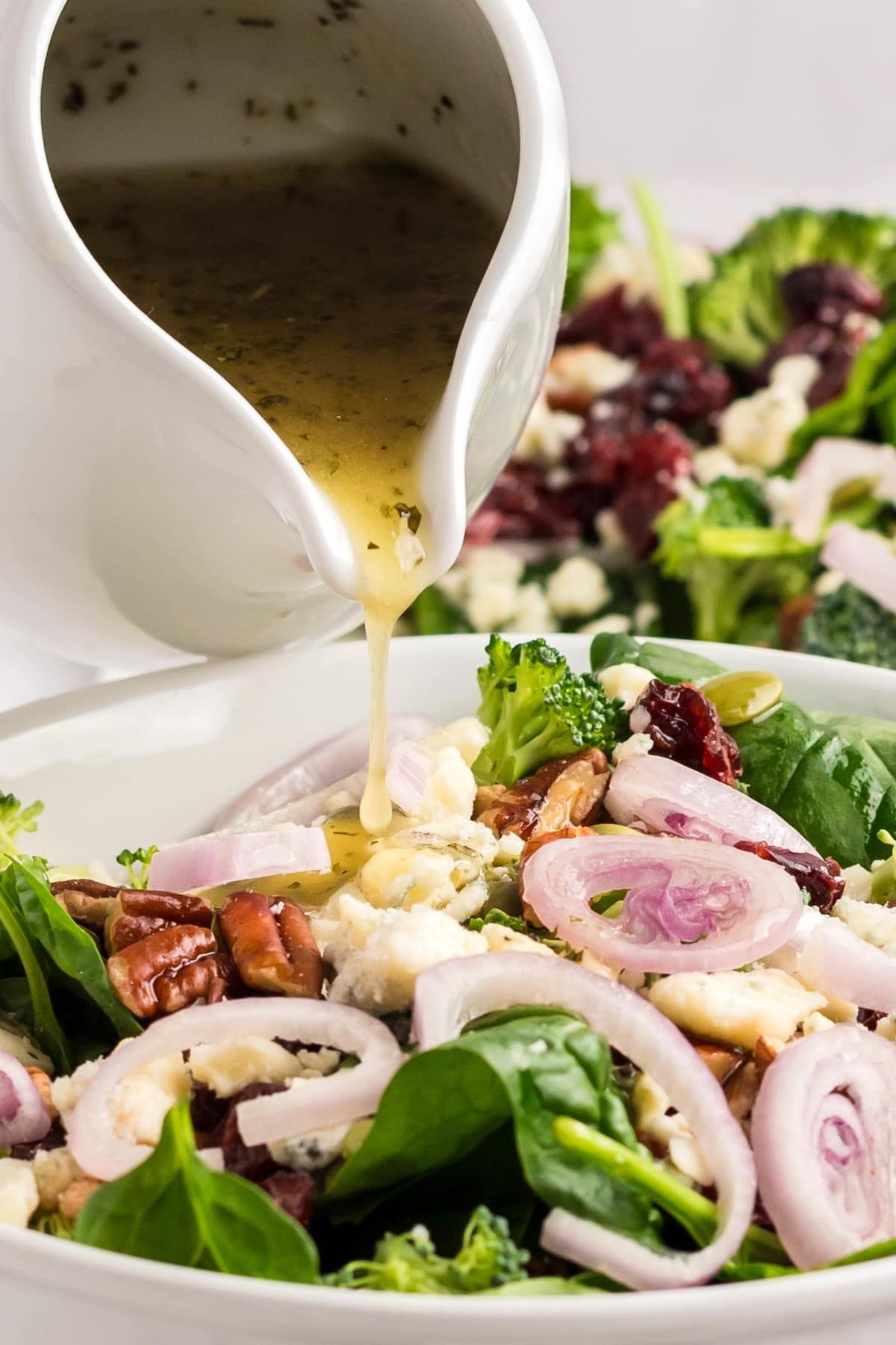 This spinach salad with Dijon vinaigrette comes together with crunchy pecans and sweet cranberries. It's simple, fresh, and has just the right balance of flavors. spinach salad dressing