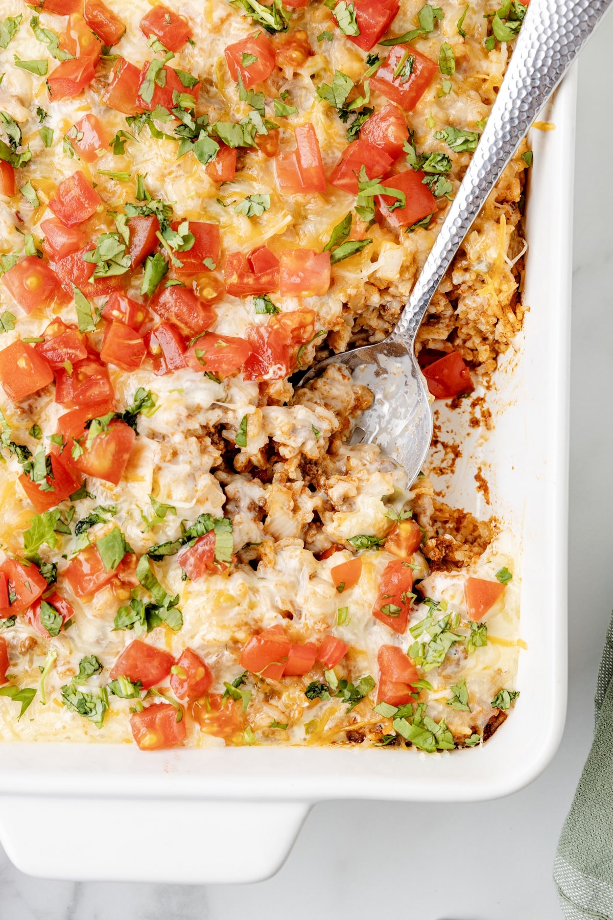 This Taco Rice Casserole is one of the easiest ways to switch up taco night. It’s layered with classic taco flavors and finished off with queso, because it makes everything better! taco rice casserole