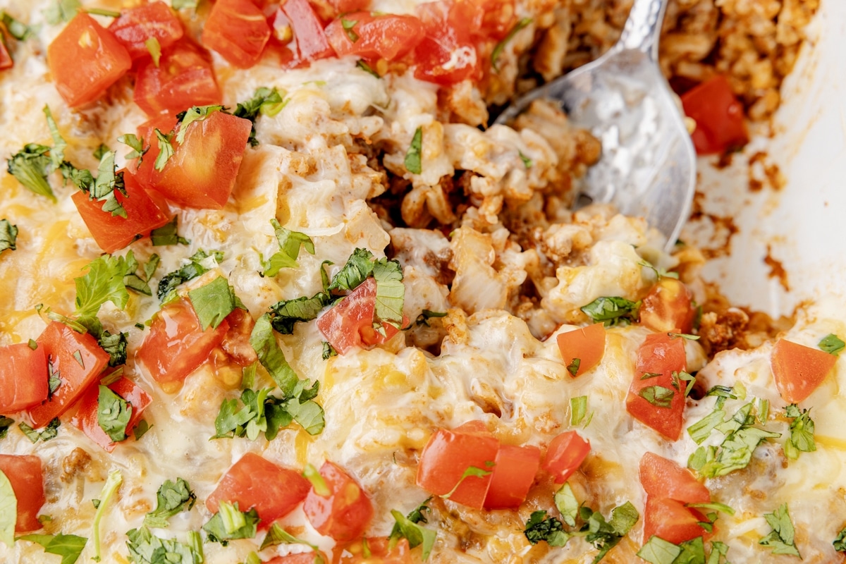 This Taco Rice Casserole is one of the easiest ways to switch up taco night. It’s layered with classic taco flavors and finished off with queso, because it makes everything better! cheesy taco rice casserole