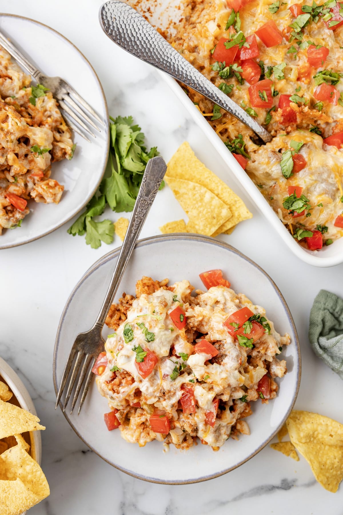 This Taco Rice Casserole is one of the easiest ways to switch up taco night. It’s layered with classic taco flavors and finished off with queso, because it makes everything better! taco rice bake