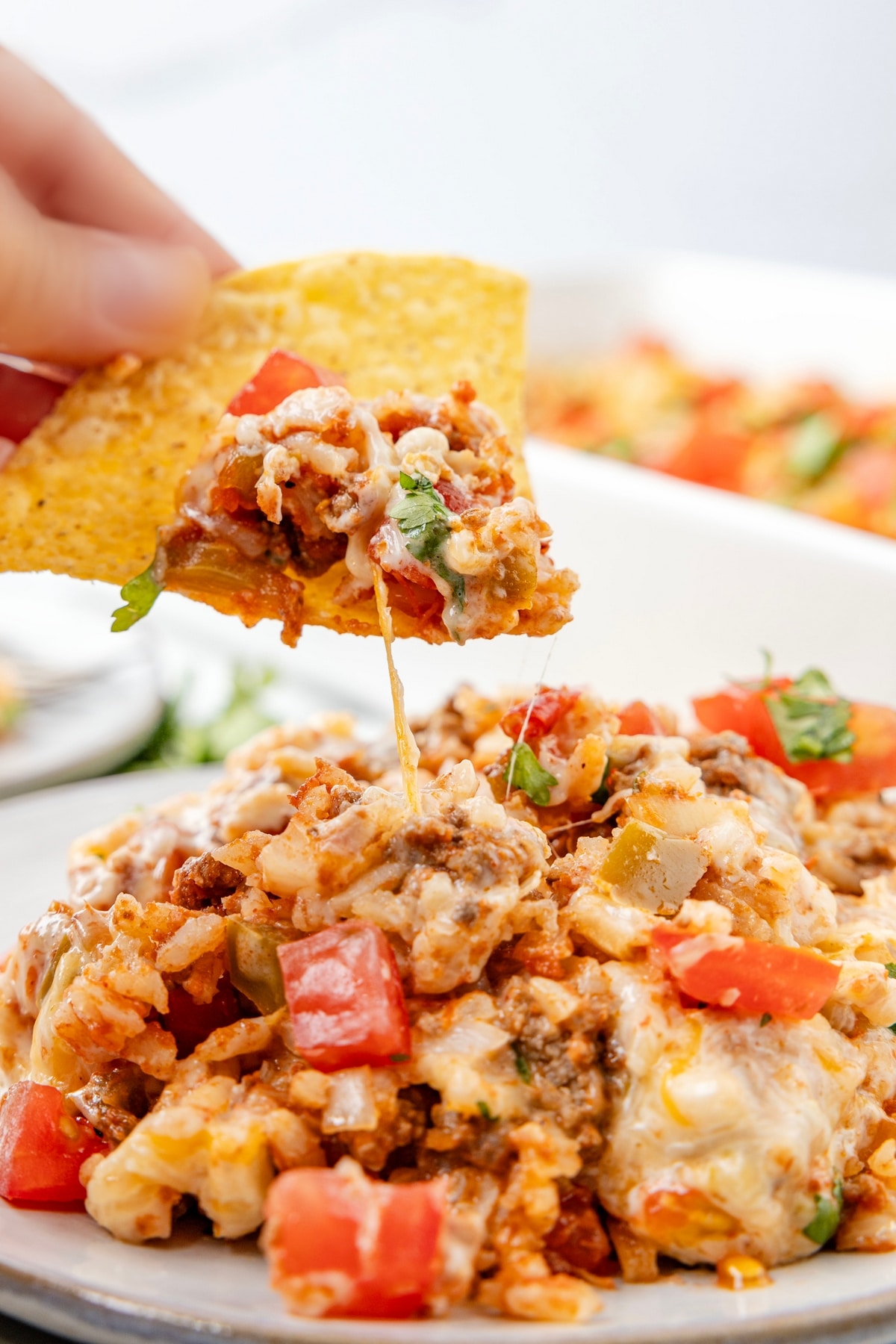 This Taco Rice Casserole is one of the easiest ways to switch up taco night. It’s layered with classic taco flavors and finished off with queso, because it makes everything better! Mexican casserole