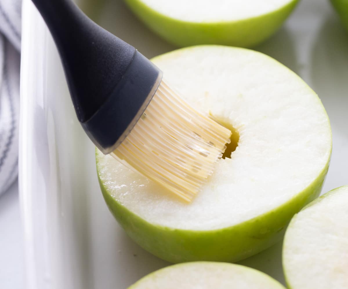 Brushing Granny Smith apple halves with lemon juice before baking