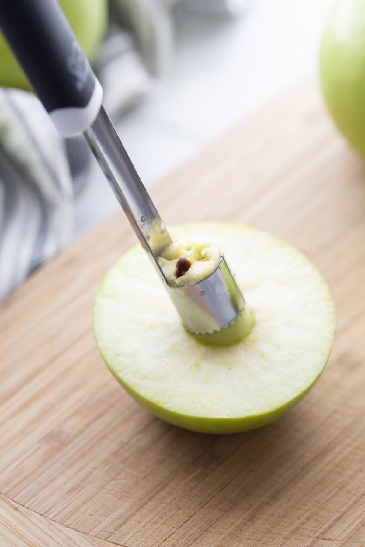Coring a Granny Smith apple for baked apples with maple syrup