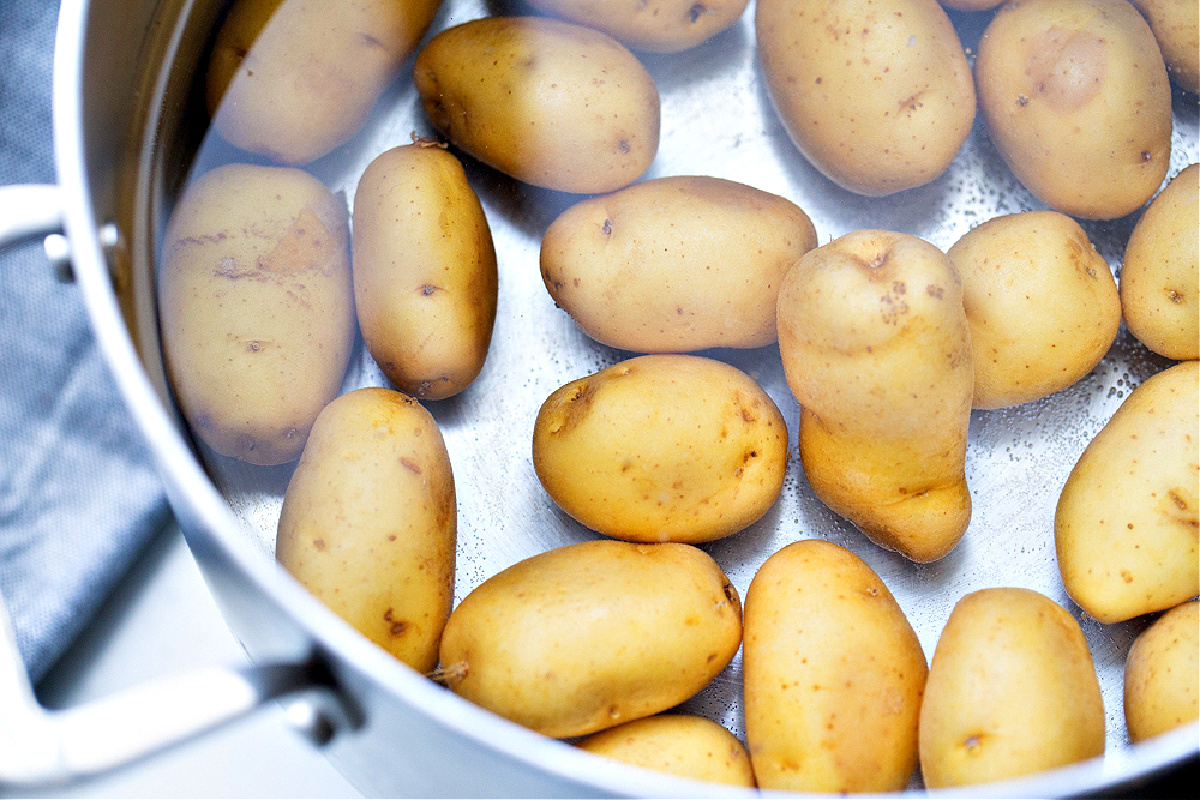 boiling potatoes, potatoes in water, prep step potatoes, cooking potatoes Small potatoes in a pot of water before boiling, the first step for making salt and vinegar smashed potatoes.
