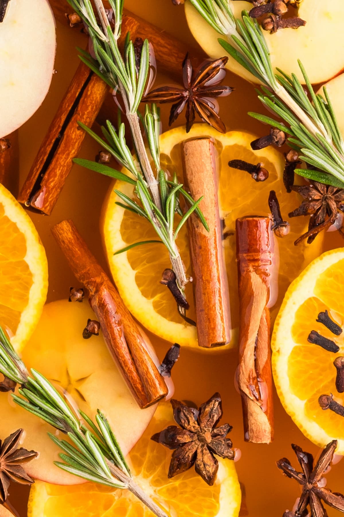 Overhead view of a simmer pot with citrus, herbs, and spices.